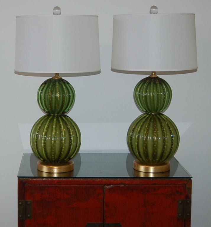 Vibrant Green stacked ball vintage Murano lamps with controlled bubbles, loaded with Gold dust.  The glass is heavily ribbed and just exquisite!  We show these mounted on Gold leafed solid wood bases, with satin brushed solid brass hardware to