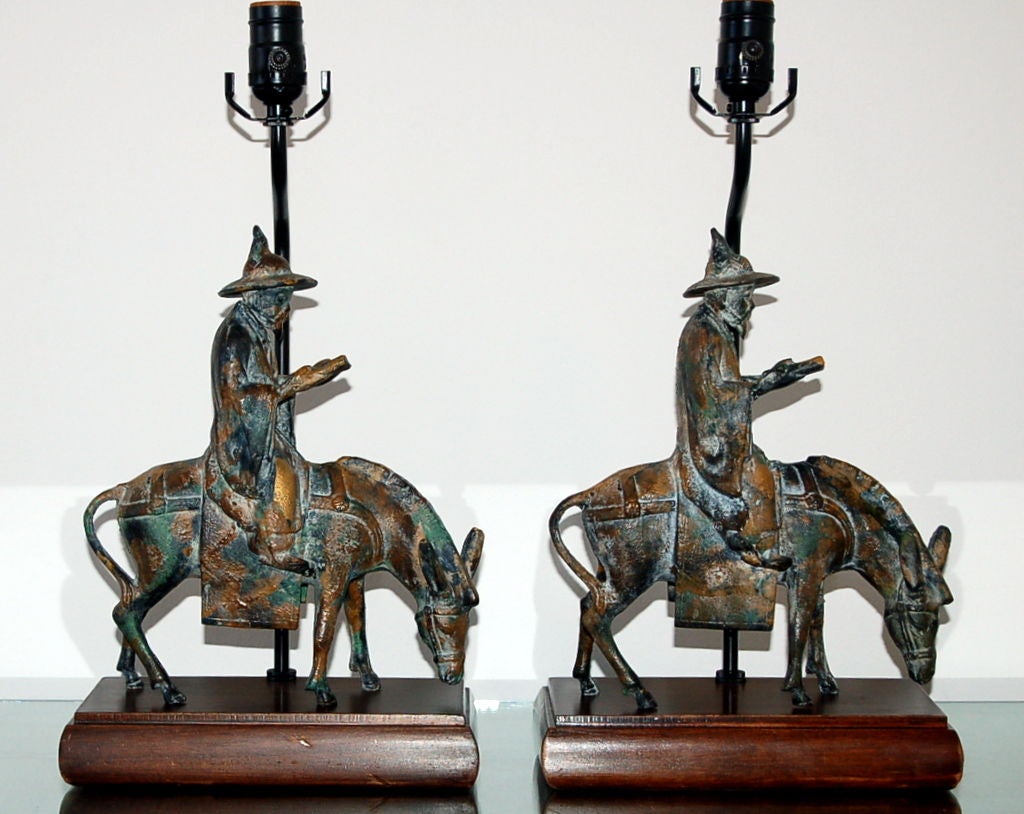 Matched pair of vintage cast bronze figurine table lamps mounted on wood plinth bases, by Frederick Cooper. The patina of the bronze is extraordinary!

The lamps are 18.5 inches high to the socket top. As shown, the top of shade is 25 inches high.