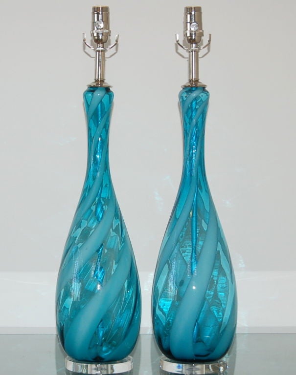 A stylish pair of vintage Italian lamps in PEACOCK BLUE with a swirling ribbon of white. They are mounted on Lucite, the hardware is nickel plated solid brass.

The lamps measure 27 inches from tabletop to socket top. As shown, the top of shade is