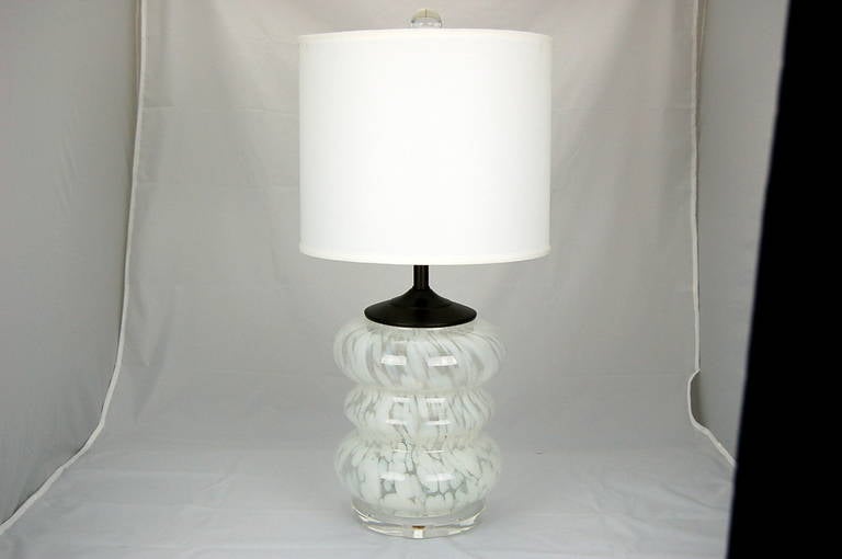 Very stylish Murano bedside lamps from the late 1960s in a rarely seen three tiered style. We've paired the mottled WHITE AND CLEAR glass with an oil-rubbed bronze finished hardware for a sleek look, shown mounted on thick Lucite discs.

The lamps