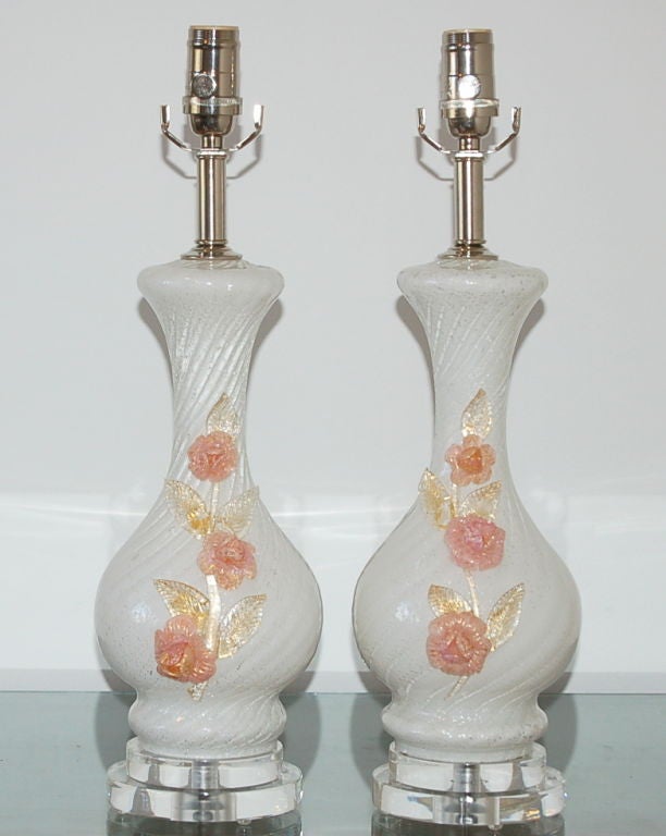 Perfectly proportioned for bedside, these elegant lamps are VANILLA Pulegoso glass with GOLD and SILVER inclusion.  Applied glass roses of SOFT PINK and GOLD filled leaves decorate the face of the lamp.

The lamps are 20 inches from tabletop to