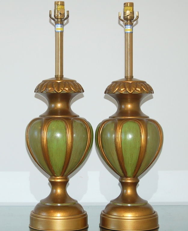 Matched pair of vintage Italian table lamps from Marbro, these in a brass toned ceramic body with inset panels of green. They look so much like brass but have the feel and ping of ceramic.

Measures: The lamps are 28 inches from tabletop to socket