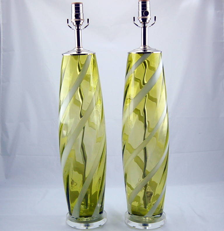 These vintage Murano glass lamps are CHARTREUSE with a ribbon of WHITE swirling up and around. We have them paired with nickel hardware and a simple disc of Lucite.

The lamps measure 26 inches from tabletop to socket top. As shown, the top of