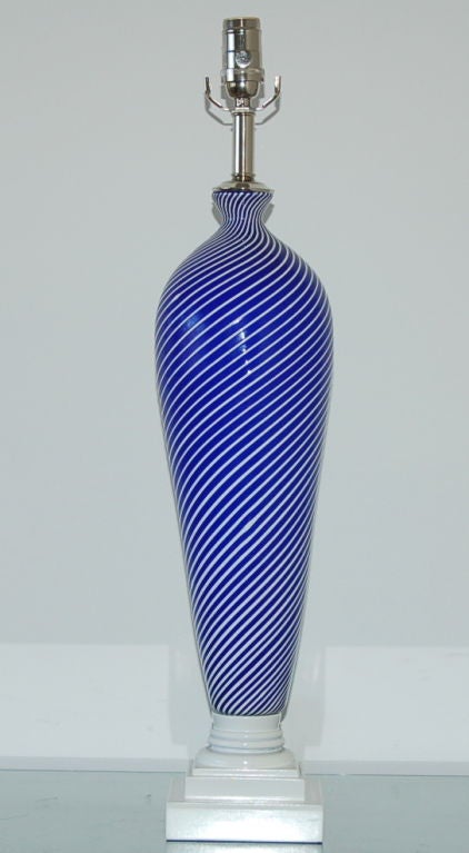 Beautiful cobalt and white striped Murano glass lamp by Dino Martens for Aureliano Toso. The shape is a Classic inverted teardrop, with a hat. Original blowers stamp and importers label still attached.

The lamp measures 27 inches to the socket