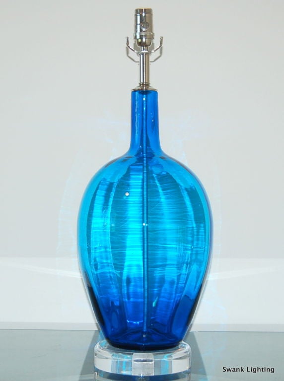 Gorgeous shape and massive size - easily the focal point of the room!  The color is best described as an electric ROYAL BLUE.  We show the lamp on a thick Lucite base and nickel plated solid brass hardware. 

The lamp measures 26 inches from