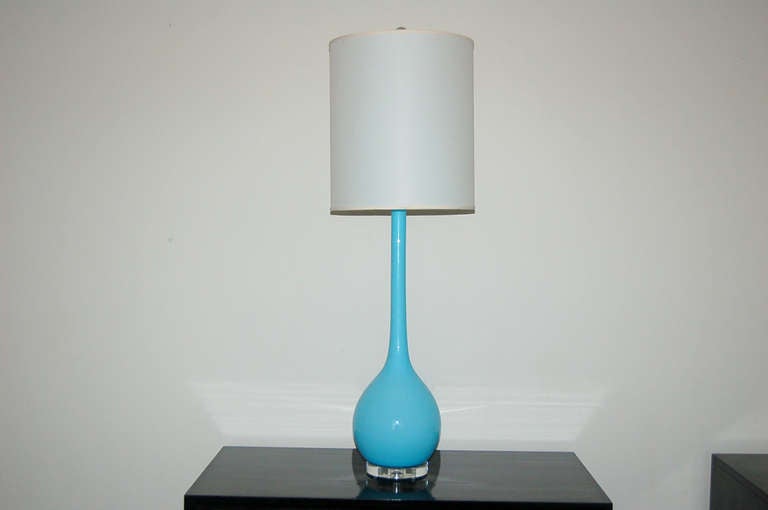 Long necked shape by Archimede Seguso, imported in the 1960's.  A layer of whited cased glass surrounded by a thick layer of T BIRD BLUE glass with Lucite base and nickel plated hardware.

These whoppers are 35 inches to the socket top; the glass