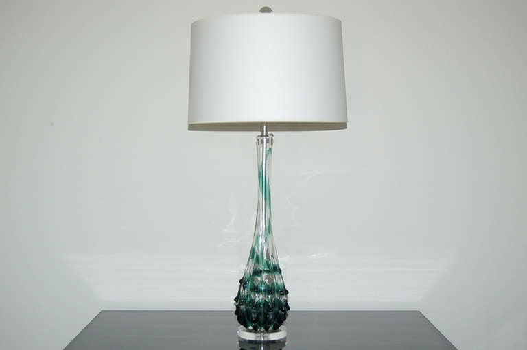 Tulip-topped lamps in clear crystal with an EMERALD GREEN drip circuitous ribbon.  Here's the fun part - as the ribbon works its way down the glass, it becomes porcupine-like quills of applied glass prunts. 

The lamps are 26 inches from tabletop