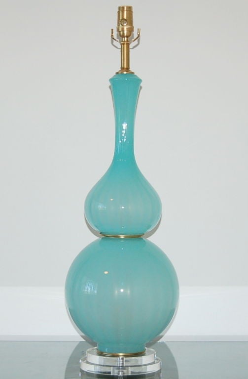 What a heavenly lamp! The opaline in the glass glows - and that's without turning on the light. The color is spectacular - our shimmering version of Tiffany blue. 

We show this mounted on a two-tiered Lucite base and use satin brushed solid brass