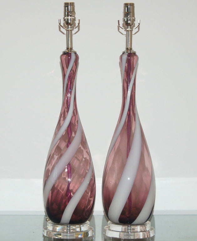 A whimsical pair of lamps in grape with a swirling ribbon of white.  We have used nickel hardware for added elegance and mounted them on double discs of Lucite.

The lamps are 27 inches from tabletop to socket top.  As shown, the top of shade is