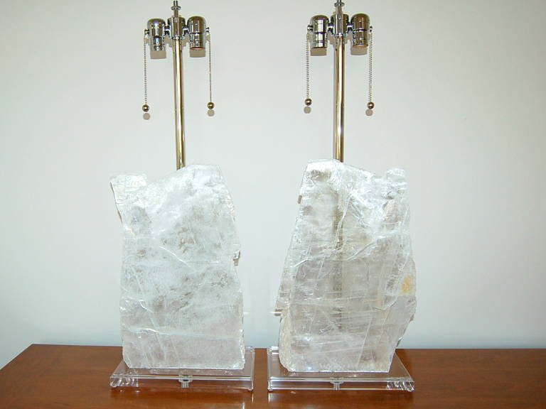 Stunning sheets of Selenite mounted on beveled Lucite plinths. Downward facing double-lights shine upon each slice, providing an ethereal glow when lit. 

The lamps are 29 inches to the socket top, (the slabs are approximately 16 inches high and