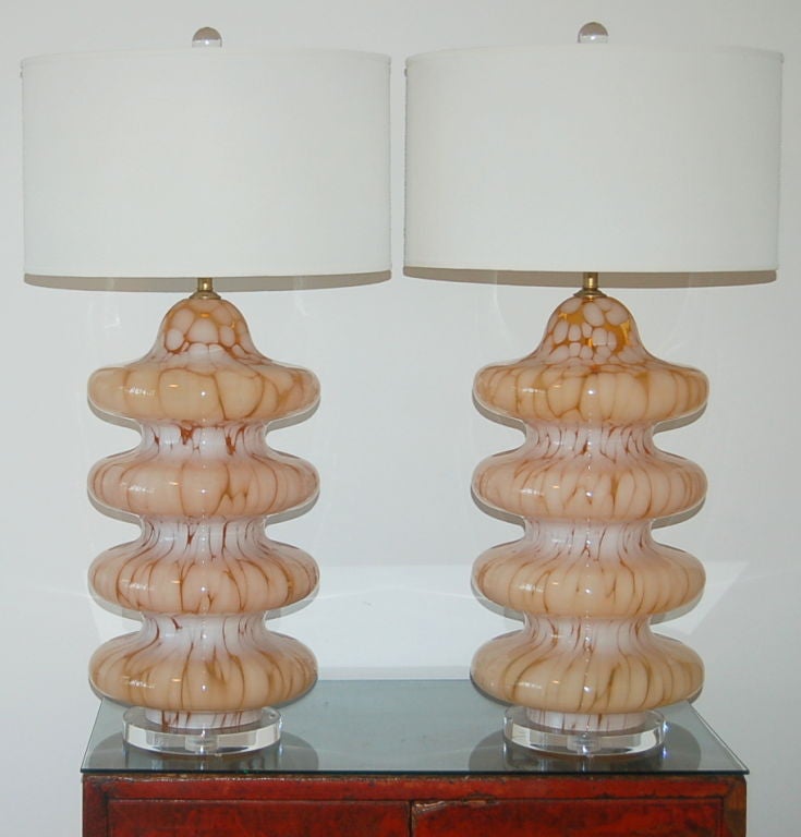 Matching pair of vintage Murano table lamps in TANGERINE and WHITE. Extremely imposing four-tiered mottled glass with satin brass hardware and thick discs of Lucite at the base.

The lamps measure 22 inches to the socket top. As shown, the top of