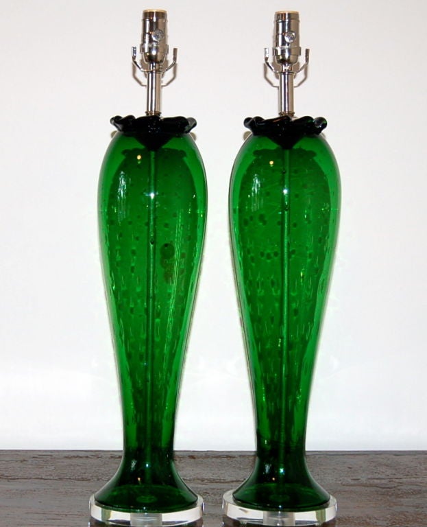 Softly curved beauties in a deep KELLY GREEN with fluted base and crimped rigaree neck.  These sculptural Murano lamps are loaded with large, controlled bubbles.  We show these with bases of acrylic and nickel plated hardware.

The lamps are quite