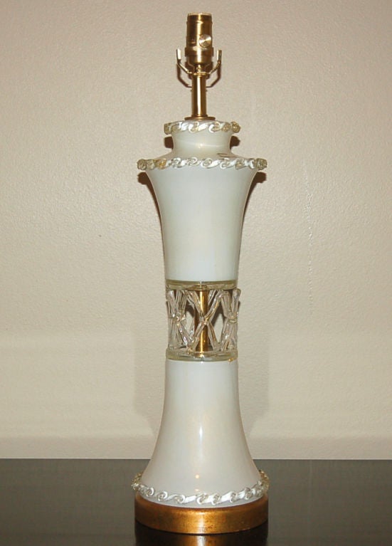 Beautiful vintage Murano wedding cake lamp, circa 1949. The creamy Vanilla glass is loaded with 23-karat gold sprinkled throughout. Two glass pieces are connected by a row of large, gold filled X's. Rows of rigaree ice the cake, as it were.

We