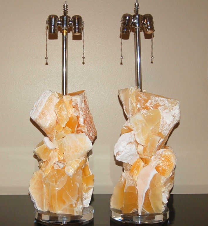 Glorious sculpted lamps of tangerine calcite mined from Arizona in 1980.  Incredibly vibrant hues of TANGERINE AND WHITE.  Gorgeous eco-friendly art pieces that really light up a room - designed by Swank Lighting. 

The lamps are 27 inches from