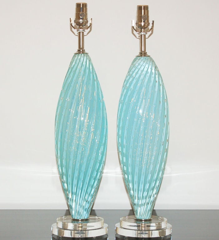 Beautiful pair of BABY BLUE vintage Murano lamps, hand blown by Barbini in the mid 20th century.  Swirled vertical ribs with controlled bubbles blown into beautiful light blue opaline glass.  Mounted on double Lucite platter bases with nickel plated
