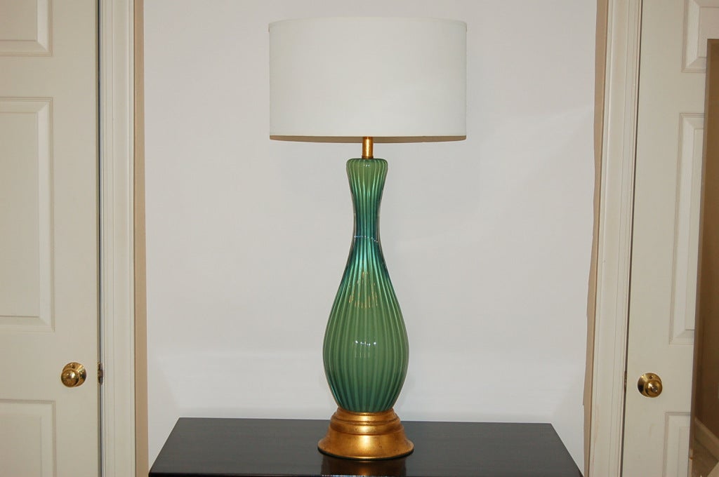 Vintage Murano lamps in green are hard to find - there just weren't that many made. This monumental beauty is Jade green with highlights of yellow green. Sexy high waisted profile, vertical ribs and gold leafed base and neck - this will be the