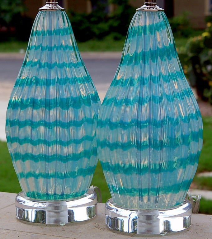 These Murano lamps have a whimsical Anzola Fuga flavor to them. The Opaline glass has ribbons of WINTERGREEN that swirl in an ascending pattern.  The light from the downward facing double sockets really make the colors pop.

The lamps measure 25