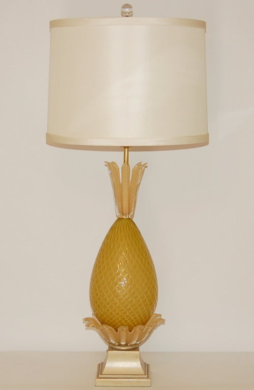 A spectacular and rare lamp, destined to be the focal point of your room. Beautiful yellow gold opaline vintage Murano glass blown as a pineapple, mounted on a wooden plinth of French Provincial style. 

The lamp measures 33 inches from tabletop
