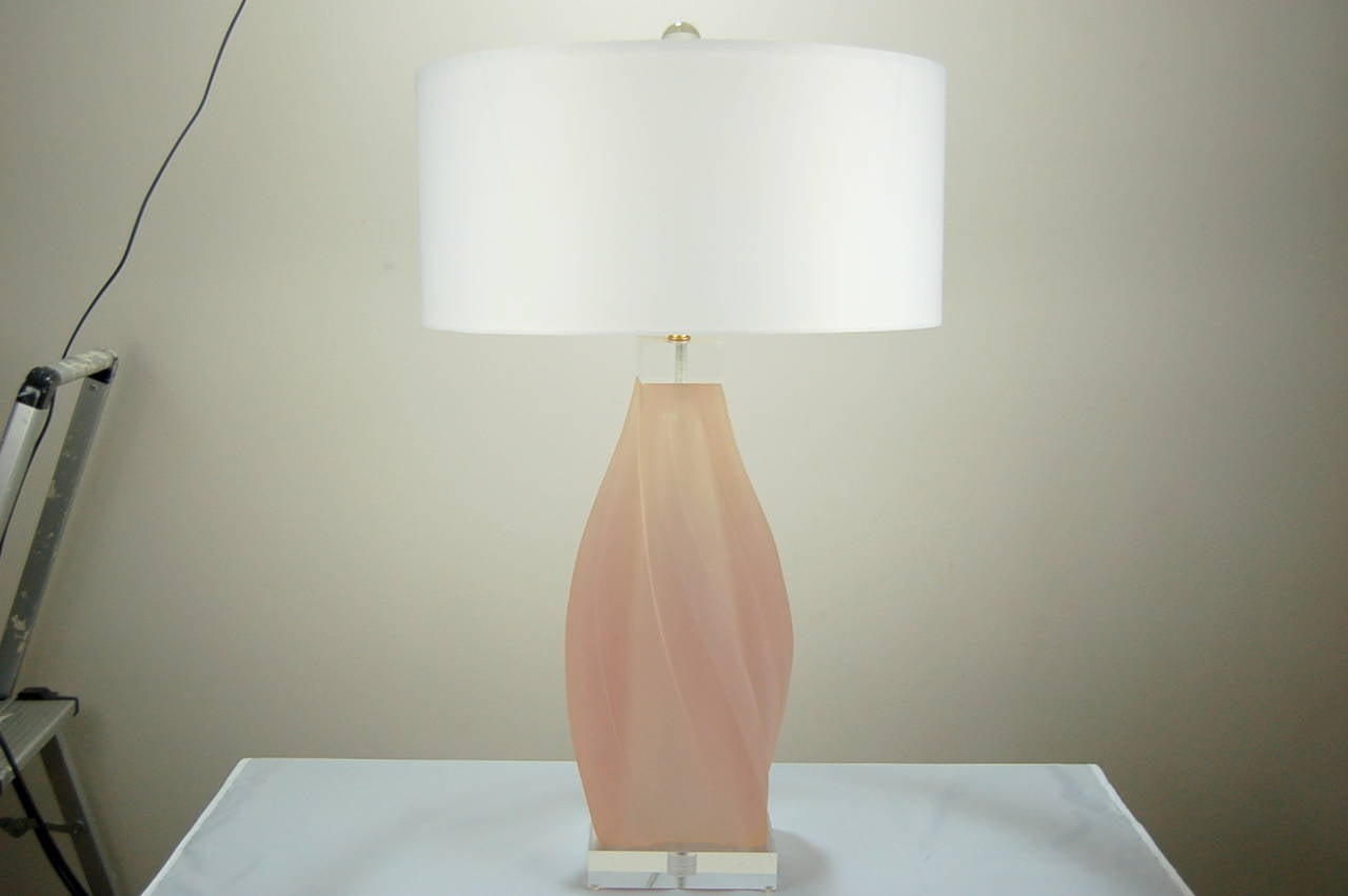 Sculptural acrylic lamps in PALE PINK, designed, and signed, by Paolo Gucci. Each lamp is a solid chunk of acrylic, with Lucite base and end cap. 

The lamps are 26 inches from tabletop to socket top. As shown, the top of shade is 31 inches high.