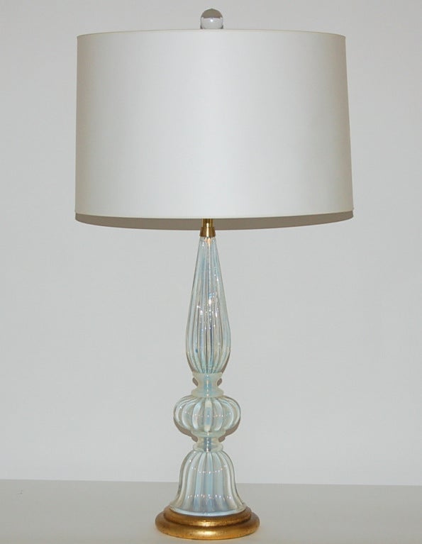 Spectacular pair of vintage Murano lamps in WHITE OPALINE.  The glass was created while lead was blown into the glass - that's what gives these lamps their magical LIGHT BLUE translucence. 

These lamps were imported by The Marbro Lamp Company,