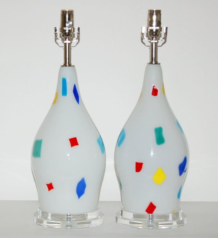 Very colorful pair of vintage patch work glass lamps by Dino Martens for Aurileano Toso from the 1950's.  Beautiful and rare.  Mounted on two tiered Lucite bases with new nickel plated brass hardware.

The lamps measure 24 inches from tabletop to