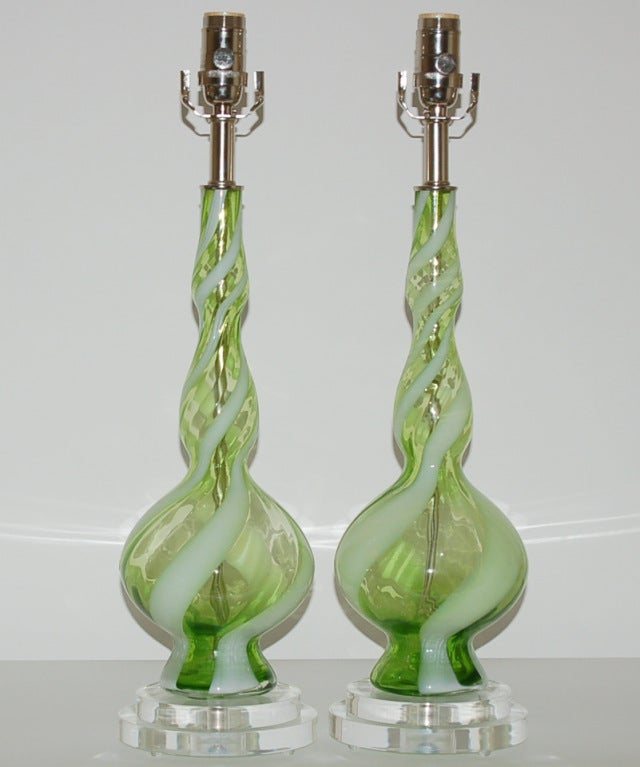 Vibrant APPLE GREEN lamps with a thick white ribbon swirl.  These are more diminutive in size and perfect for bedside.  We show these on a double tier of lucite.

The lamps measure 22 inches from tabletop to socket top.  As shown, the top of shade