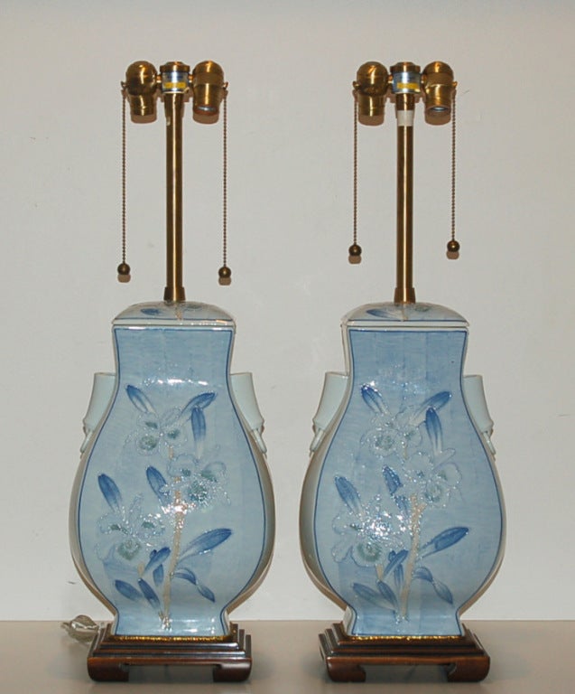 Beautiful pair of lamps from The Marbro Lamp Company with Delft styling.  Predominate colors of BLUE AND WHITE with intricate detailing on both sides.

The lamps stand 30 inches tall from tabletop to socket top.  As shown, the top of shade is 32