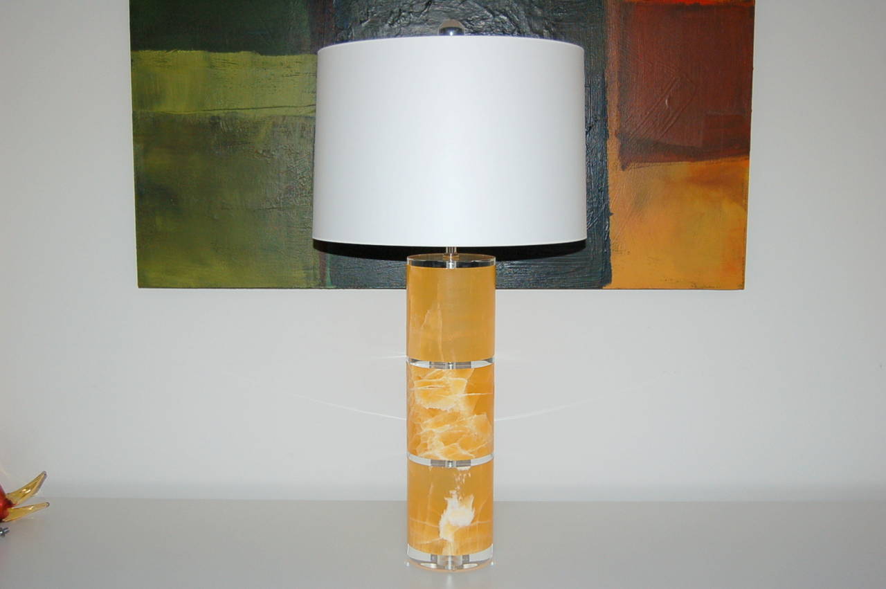 Cylindrical table lamps made of TANGERINE CALCITE by Swank Lighting. Downward facing double-lights shine down onto the Calcite, creating an ethereal glow.

Measure: They stand 33 inches from tabletop to socket top. As shown, the top of shade is 34