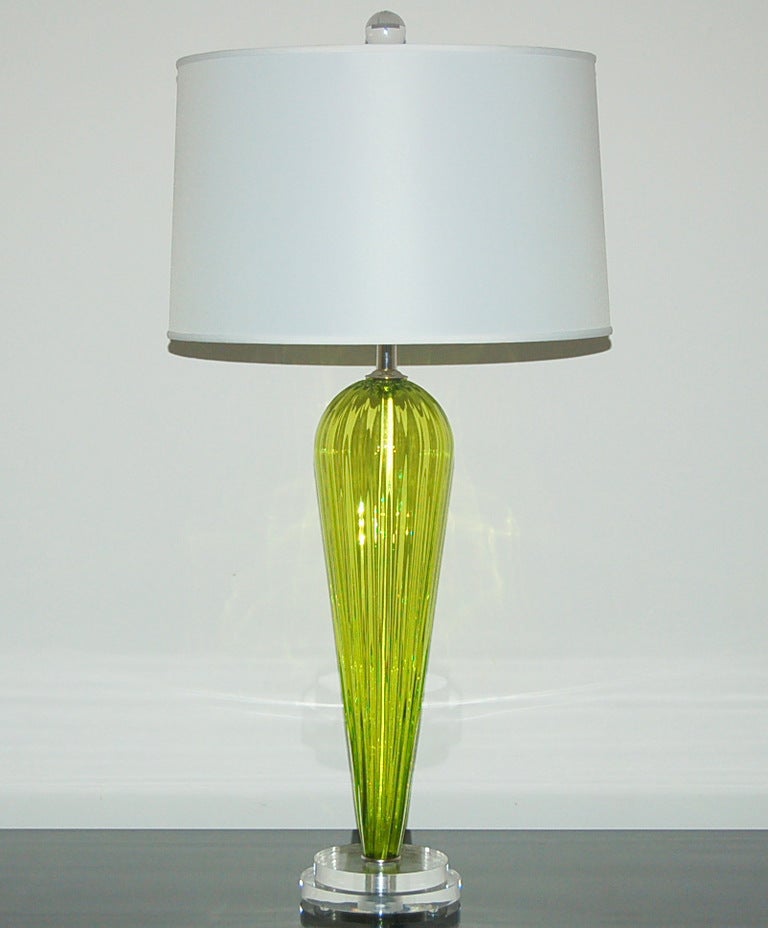 Exclusively blown for Swank Lighting by California artist Joe Cariati, these gorgeous Chartreuse lamps are signed by the artist. Eye-popping Chartreuse with vertical ribs for texture and optical enhancement.

The lamps measure 24.5 inches from