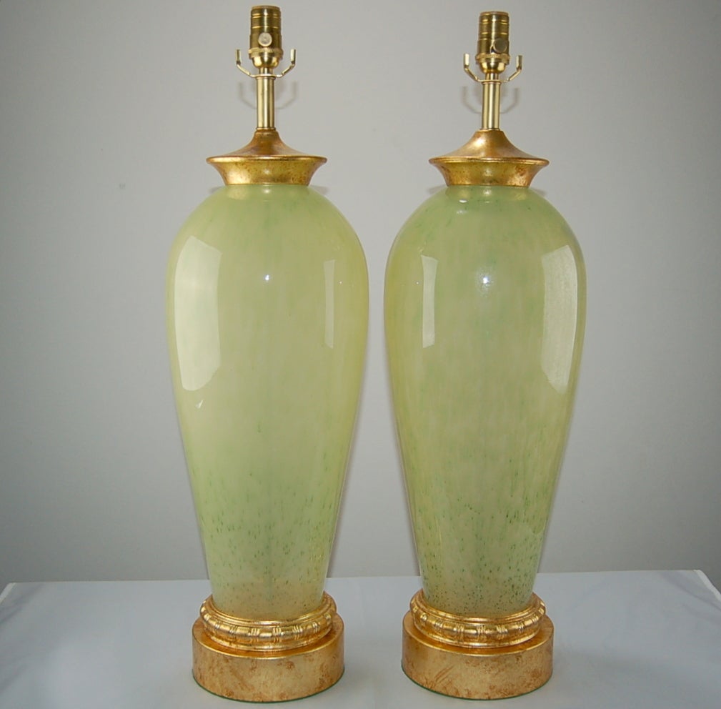 A striking pair of Murano lamps in Celadon Frost with gold flecks. There is a depth and visual texture to the glass, yet it's smooth to the touch. The glass bodies are really big and perfect for a large room.

We show the lamps mounted on gold