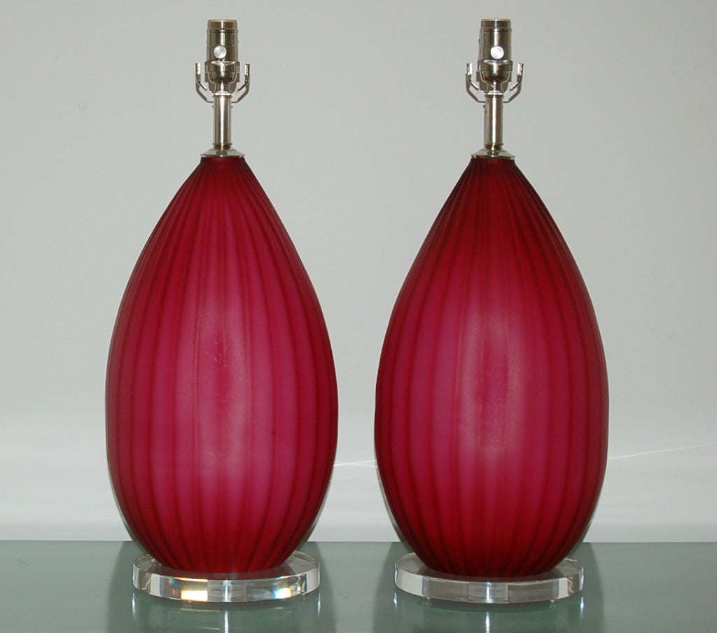 Beautiful chunky vintage Murano lamps in RASPBERRY with subtle vertical ribs.  A very vibrant color that will surely light up the room!

The lamps measure 24 inches from tabletop to socket top, and are on 10 inch Lucite bases. As shown, the top of