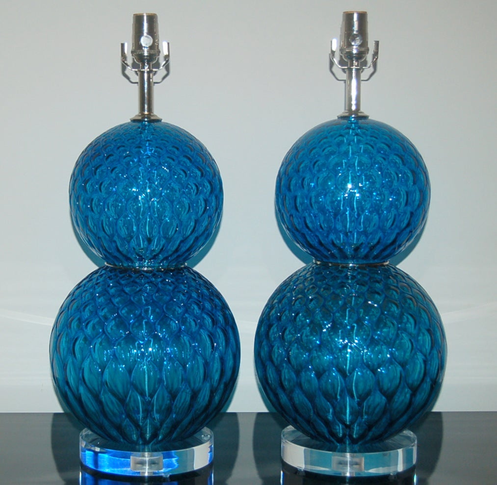 Yummy stacked ball lamps of electric MIDNIGHT BLUE, with nickel wafers at the waist.   Great texture to the glass with visual treats, courtesy of the netted optics. 

The lamps measure 23 inches from tabletop to socket top.  As shown, the top of