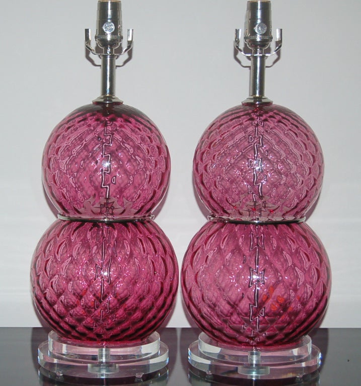 Wonderful window paned Italian glass in CRANBERRY, cinched at the waist by nickel wafers.  We have matched the double stacked balls with two steps of lucite at the base.

The lamps measure 19.5 inches high to the socket top.  As shown, the top of