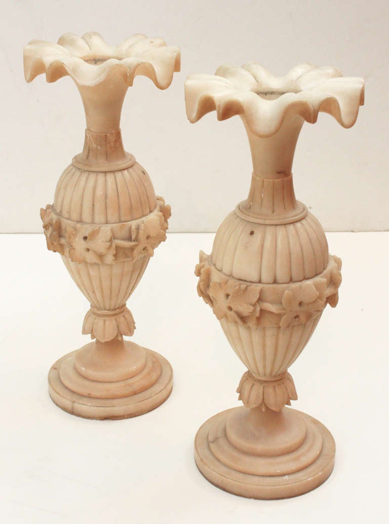 a pair of alabaster vases with melon form bodies and fluted top with ruffled edges, floral carving around gadrooned center 

several repairs / restoration (Images 6 & 7)

AS FOUND