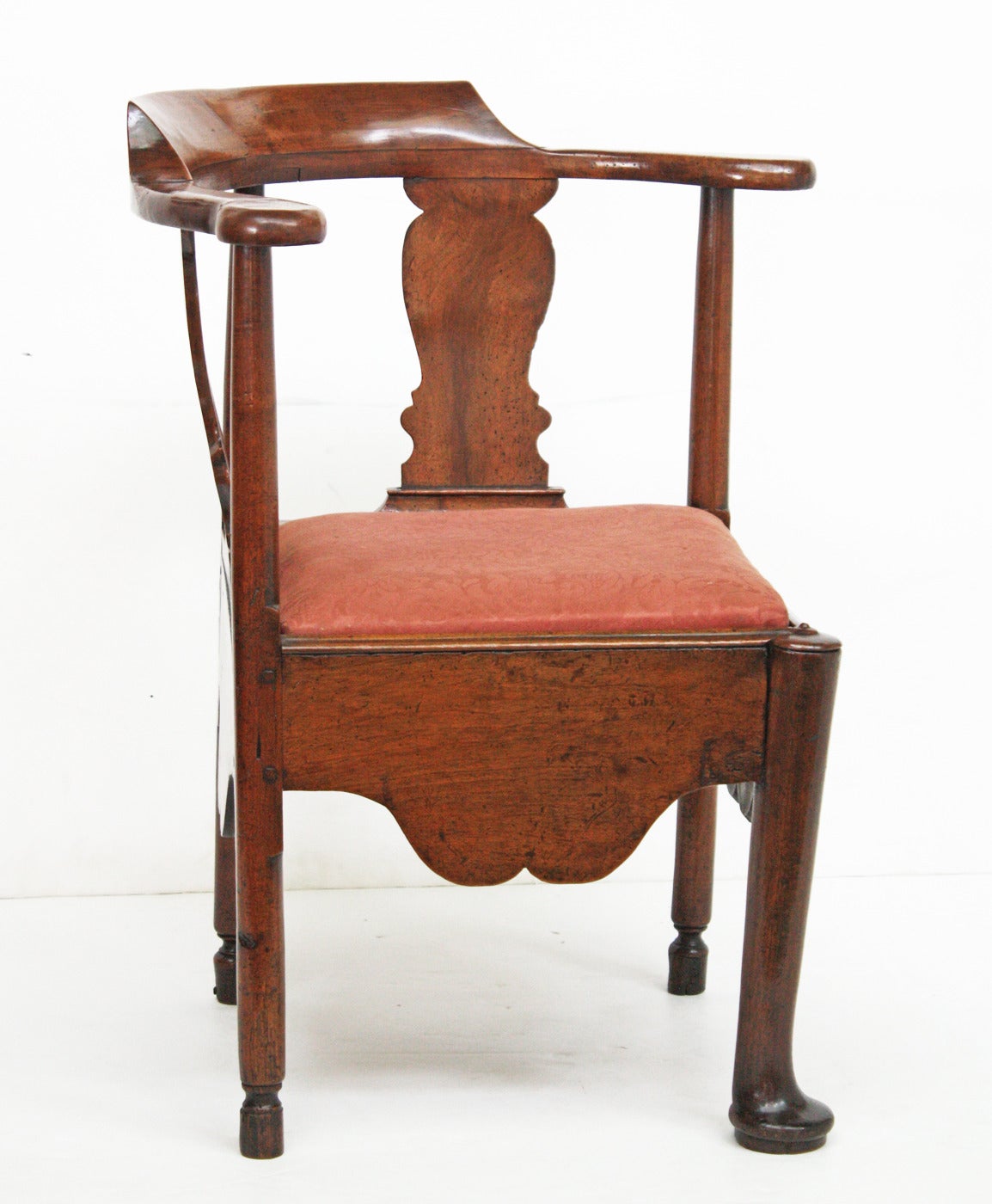 a walnut corner chair with deep apron, turned legs (the single front with a pad foot), solid shaped splats and an upholstered slip seat

pegged tenons (visible) (see Image 7)

old paper lable from a Dallas antiques shop, dated 1984 (see Image