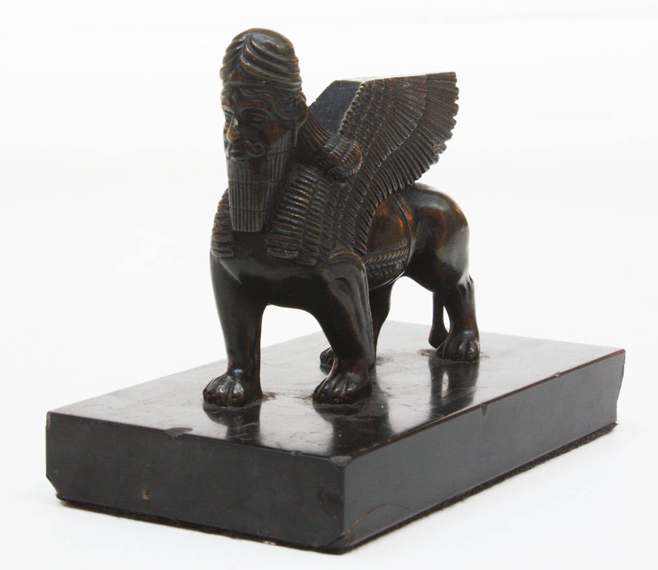 a bronze lamassu, an Assyrian protective deity, often depicted with a bull or lion's body, eagle's wings, and a human's head, on a black marble base

the Assyrians typically placed them at the entrance to cities and palaces