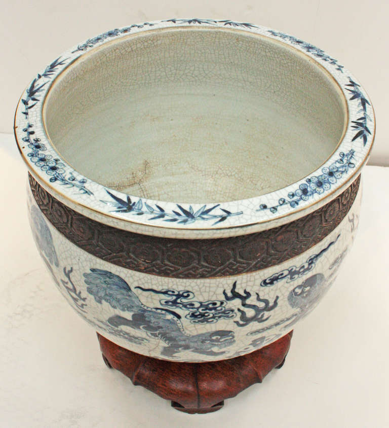 Large 19th century blue and white crackled fish bowl with stylized floral impressed brown bands at the top and bottom with a custom base.
