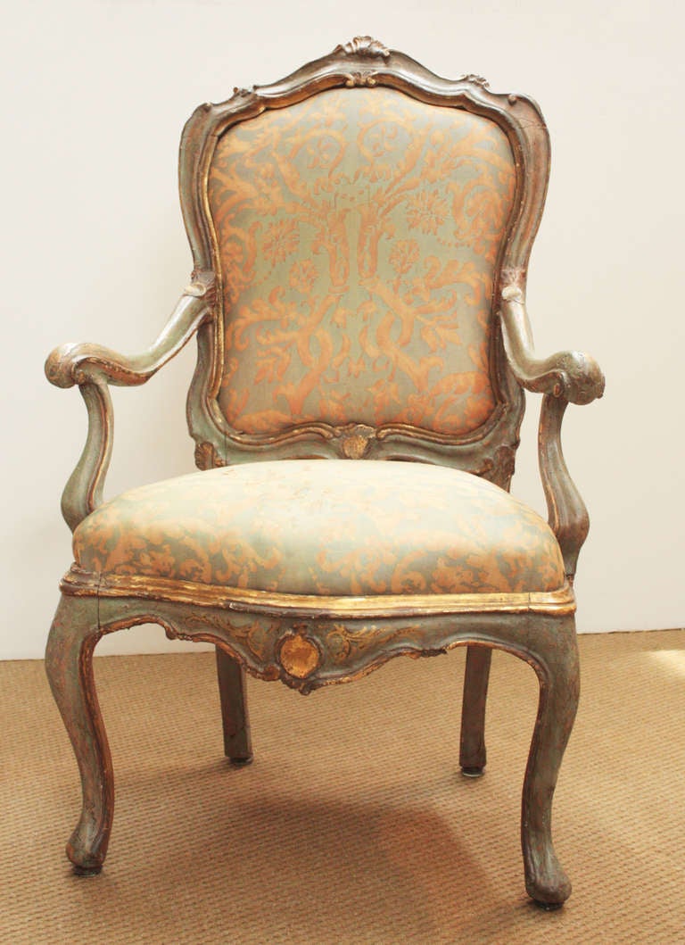 an 18th century Venetian paint and parcel gilt armchair in antique Fortuny
 