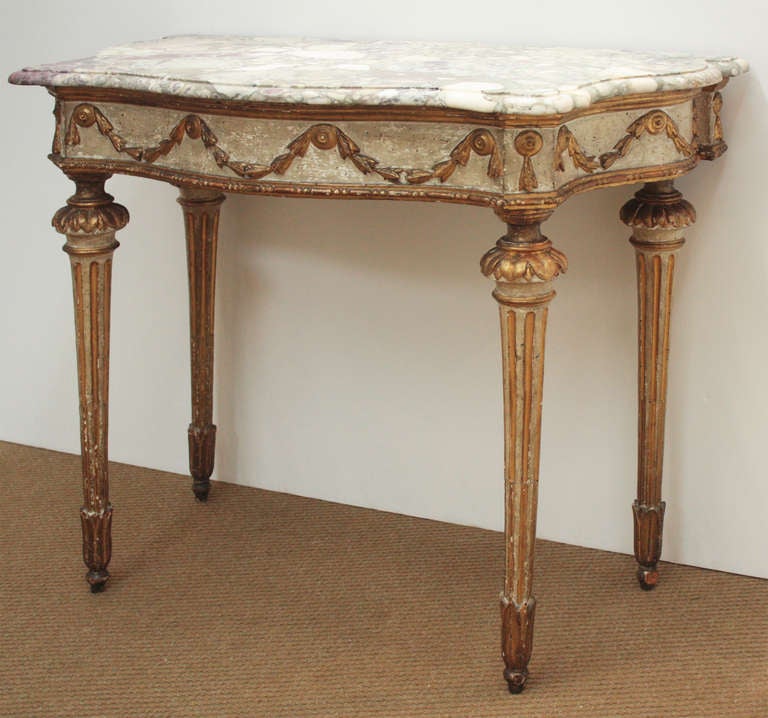 a late 18th century Italian Neo-classical paint and parcel gilt serpentine console with period shaped marble top