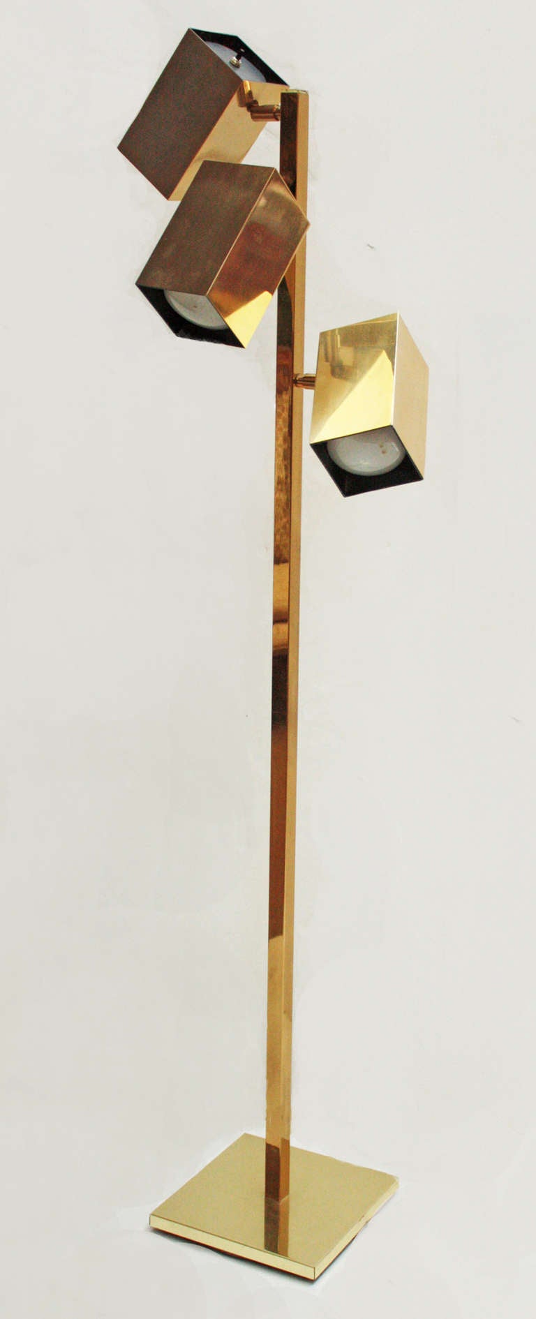 a modern brass floor lamp, three adjustable rectangular boxes with lights on a square base