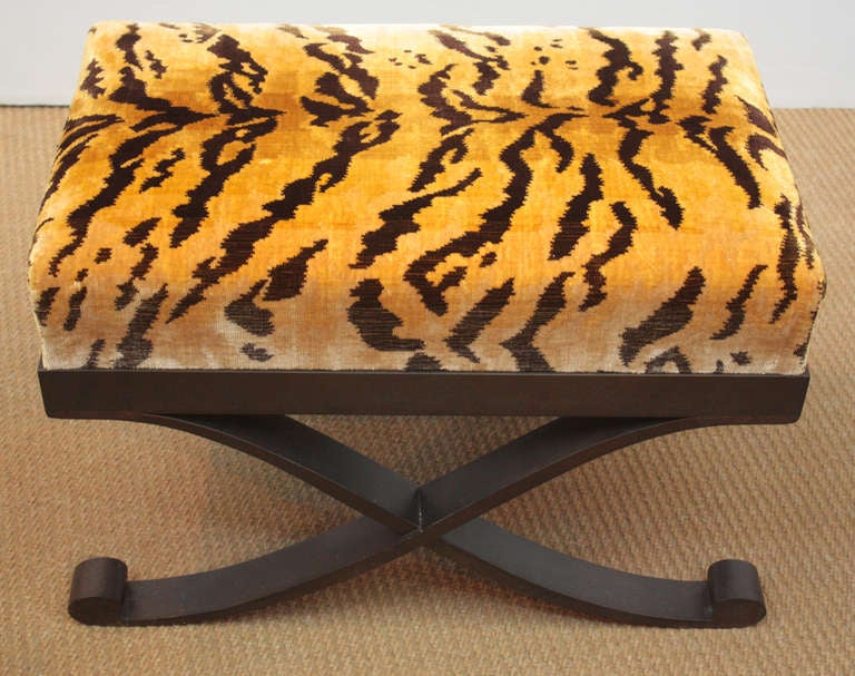 a  bronze stool / small bench with Scalamandre tiger striped upholstery