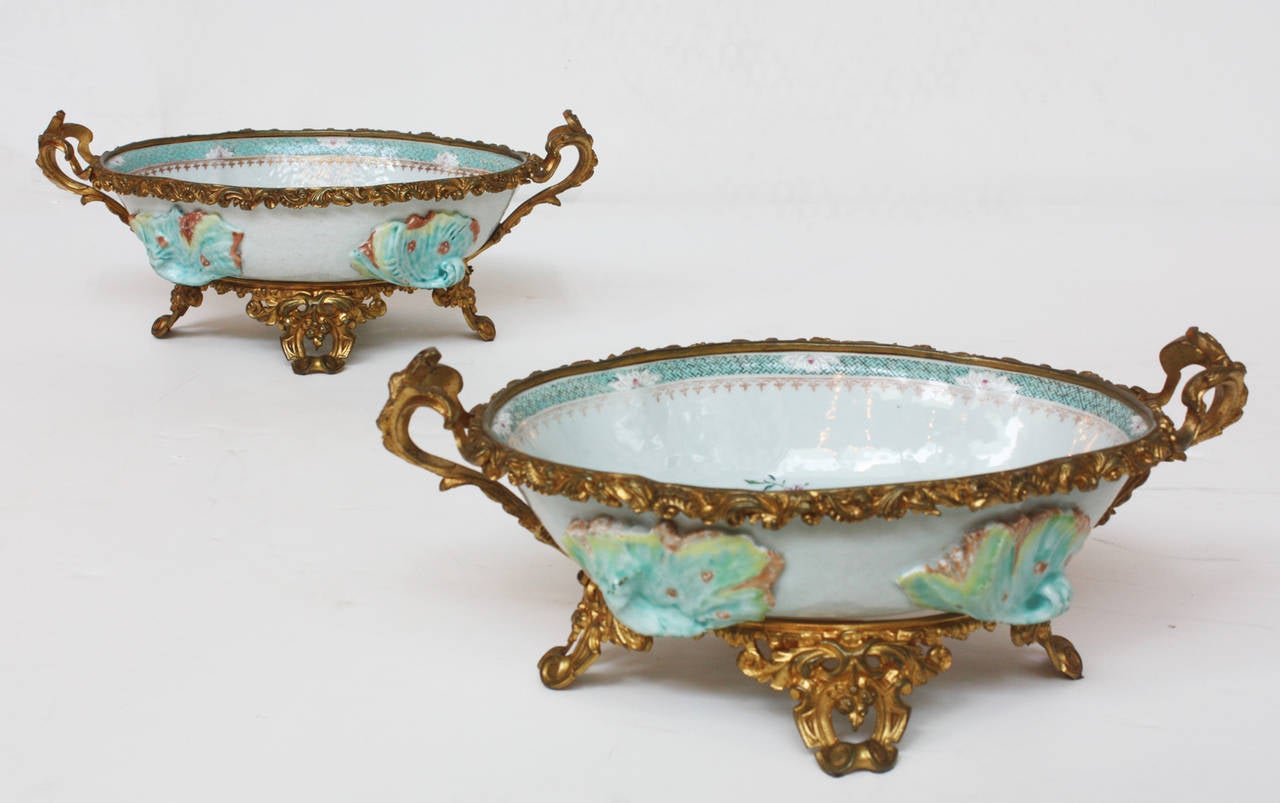 A pair of 18th century beautifully painted oval Chinese export dishes, with birds and flower. 19th century French gilt bronze mounts