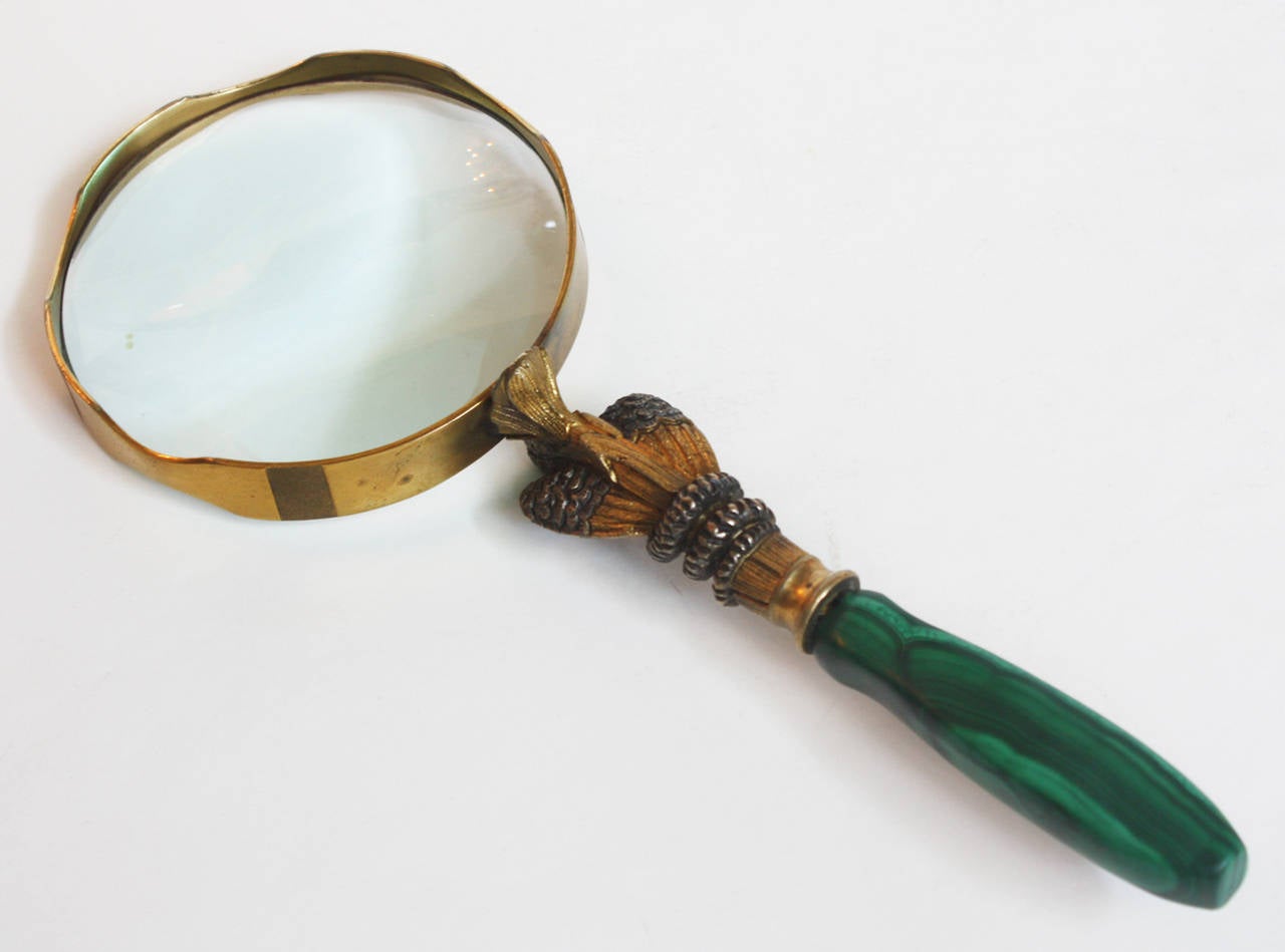 a magnifying glass with handle of malachite with gilt bronze and silvered bronze in the form of a pelican or other bird with a snake's head clamped in its mouth, unmarked and  unsigned

possibly Texas artist Robert Whiteside (1950-2006) (known for