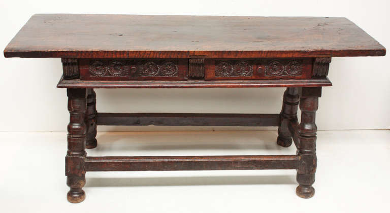 a carved (front and back) 17th century walnut table with two drawers, top is a single plank almost 1.5