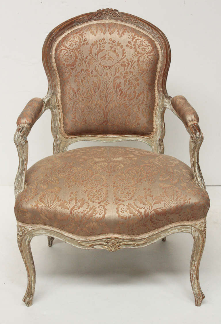 a petite Louis XV period fauteuil, carved and painted frame, new Fortuny upholstery