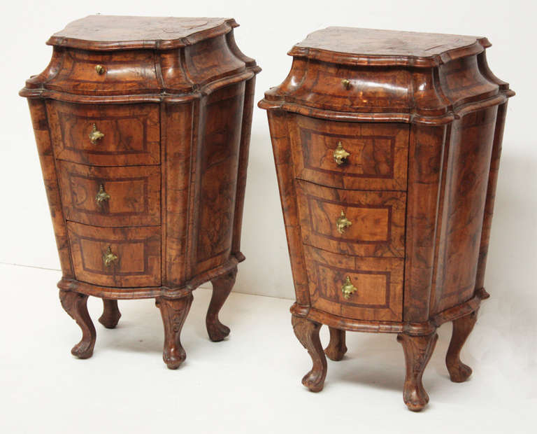 a pair of early 19th century petite Italian commodes with a slanting curved top drawer above three drawers with beautiful burled wood, curved legs / feet