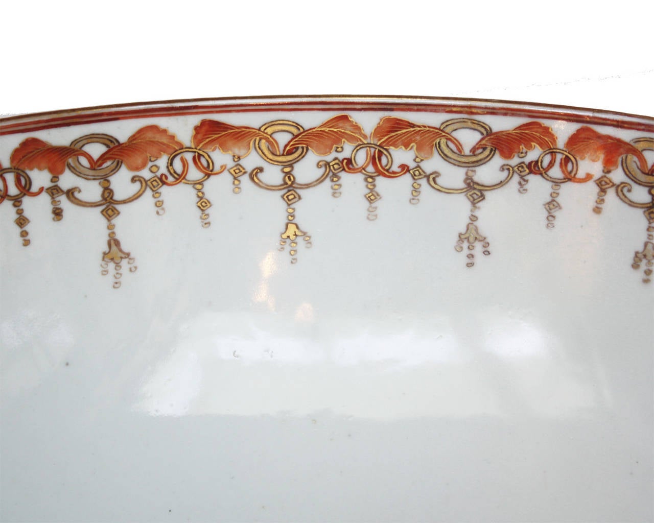 an 18th century Chinese Export porcelain finely decorated punch bowl on carved wooden stand
