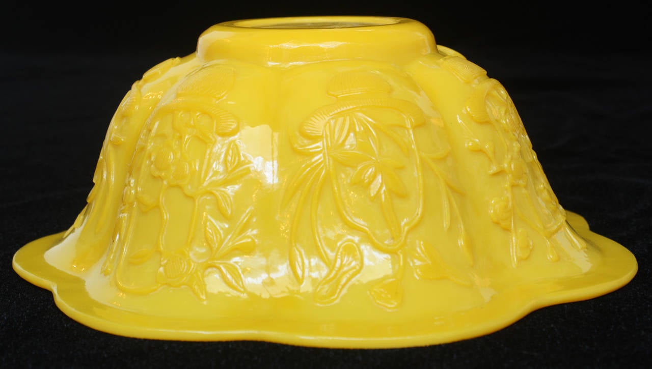 Egg-yolk color yellow glass bowl  with fluted rim, carved in Oriental style, unsigned or marked. Stand is included. Very good condition without any cracks or chips

Dimension of bowl on stand are:
5