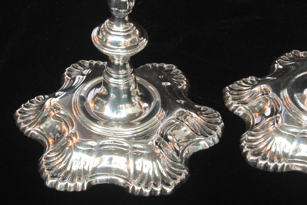 a pair of cast sterling candlesticks, period George II / circa 1750, by London silversmith John Cafe, knopped and fluted stems terminating in hexafoil bases

33.7239 troy oz.