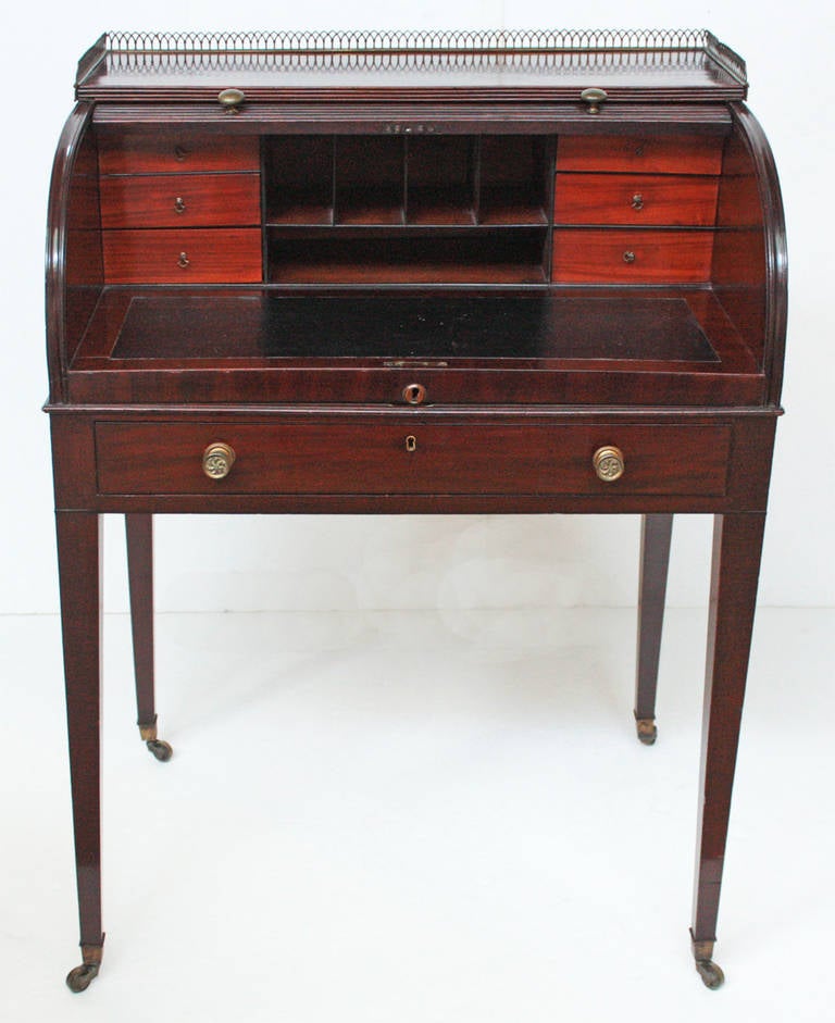 A George III mahogany desk with a cylinder tambour.
